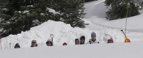 Dr. Friend (second from left) and students in a snowpit.