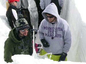 Measuring snow water equivalent (SWE).